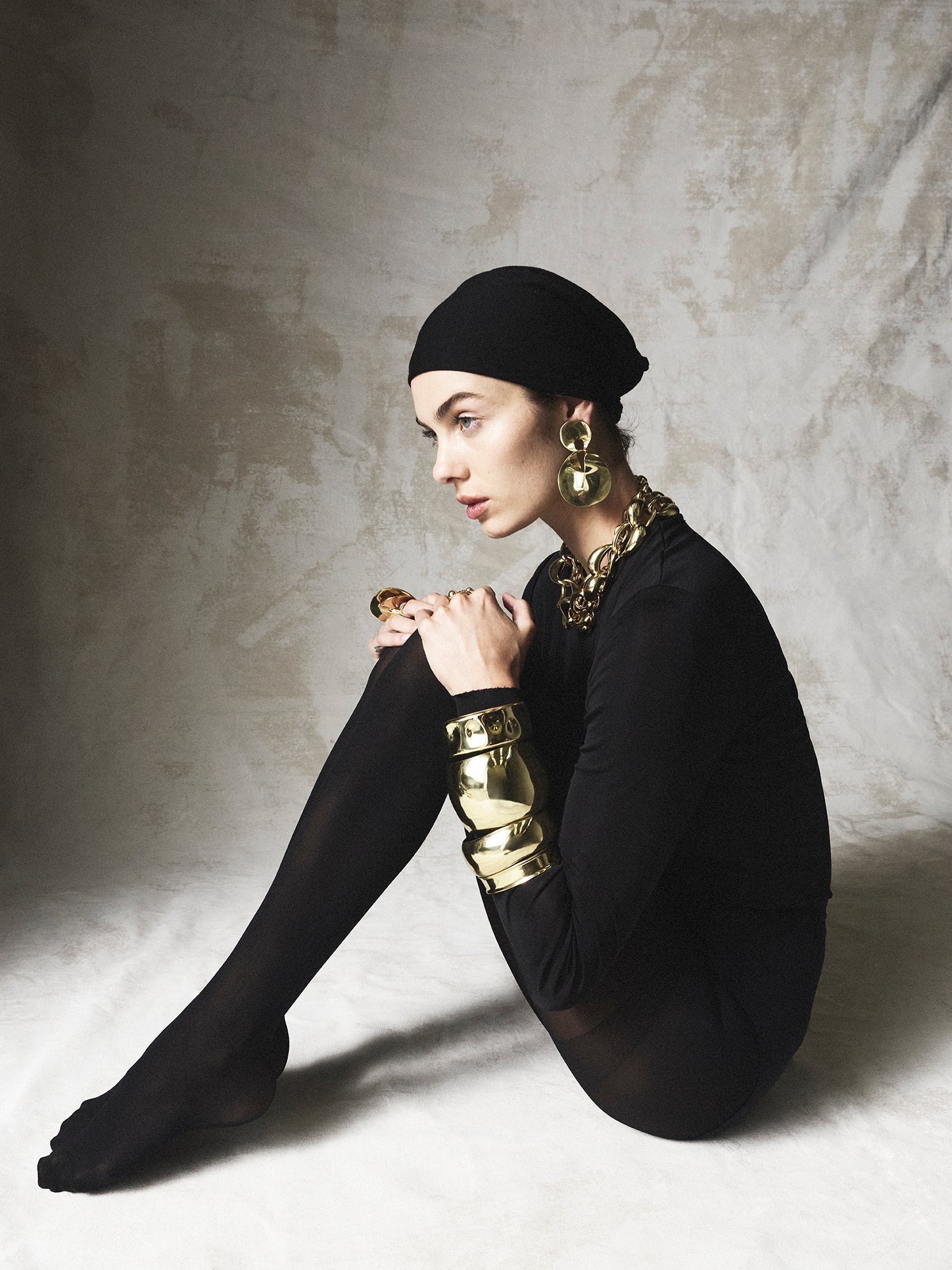 Model wearing variety of brass jewellery