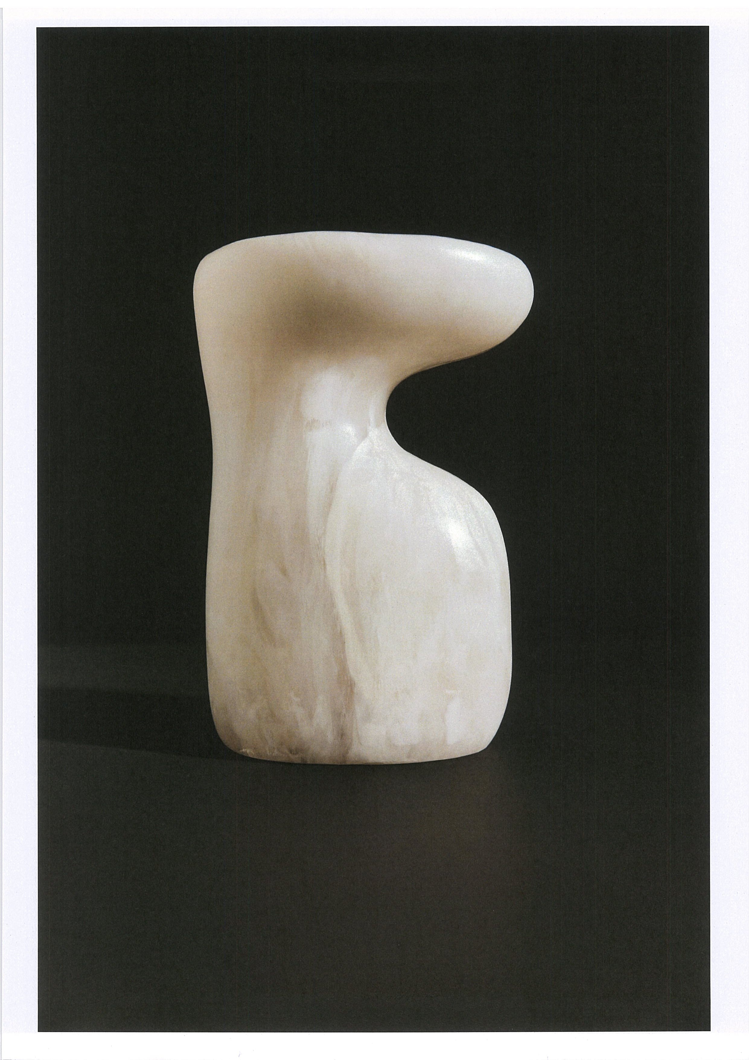 White marble sculpture on a black background
