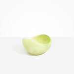 Dinosaur Designs Large Beetle Bowl in Pistachio — handcrafted pale green resin bowl with rounded organic form and pinched open rim
