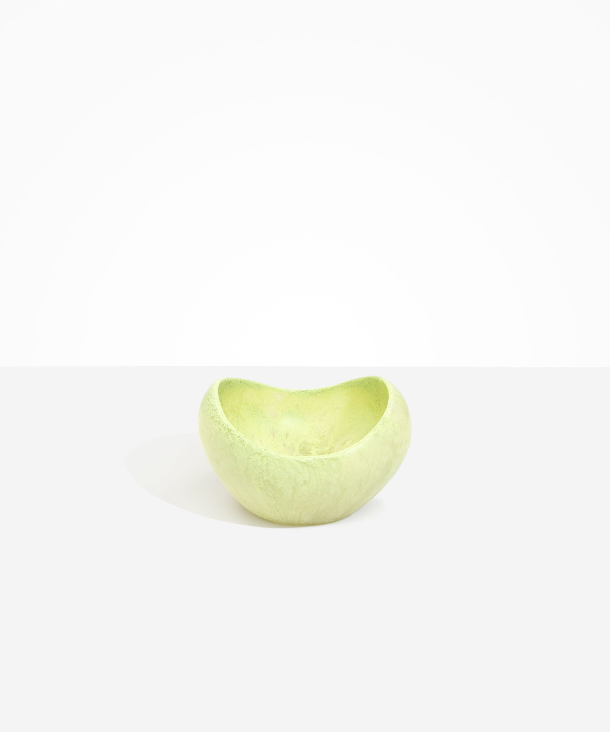 Dinosaur Designs Medium Beetle Bowl in Pistachio — handcrafted pale green resin bowl with rounded organic form and pinched open rim