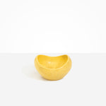 Dinosaur Designs Medium Beetle Bowl in Pollen — handcrafted yellow resin bowl with rounded organic form and pinched open rim