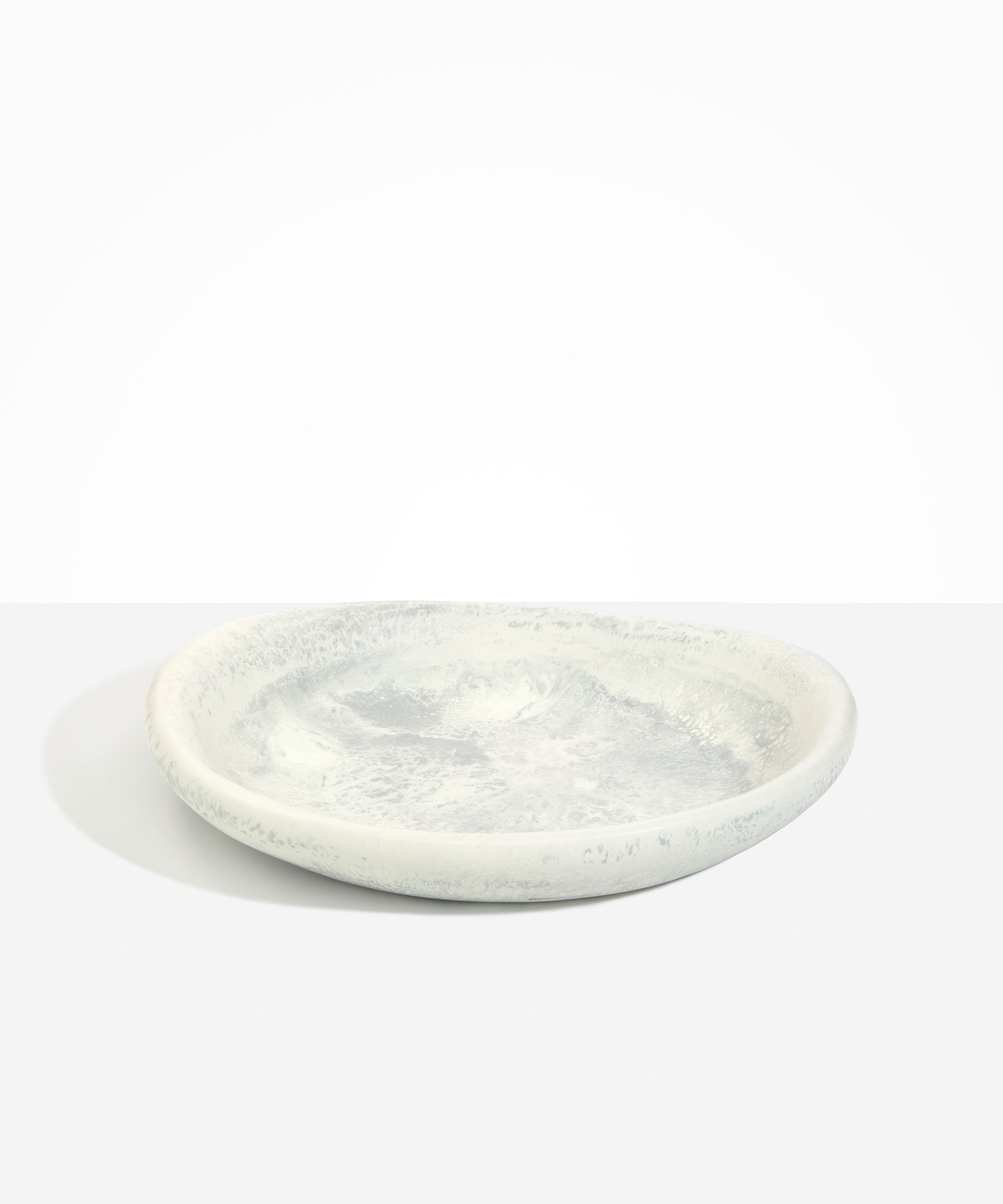 Dinosaur Designs Large Bones Bowl in Cloud — handmade marbled cream and grey resin shallow serving bowl with a rounded organic form..