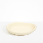Dinosaur Designs Large Bones Bowl in Cream — handmade cream resin shallow serving bowl with a rounded organic form..