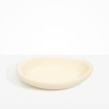Dinosaur Designs Large Bones Bowl in Cream — handmade cream resin shallow serving bowl with a rounded organic form..