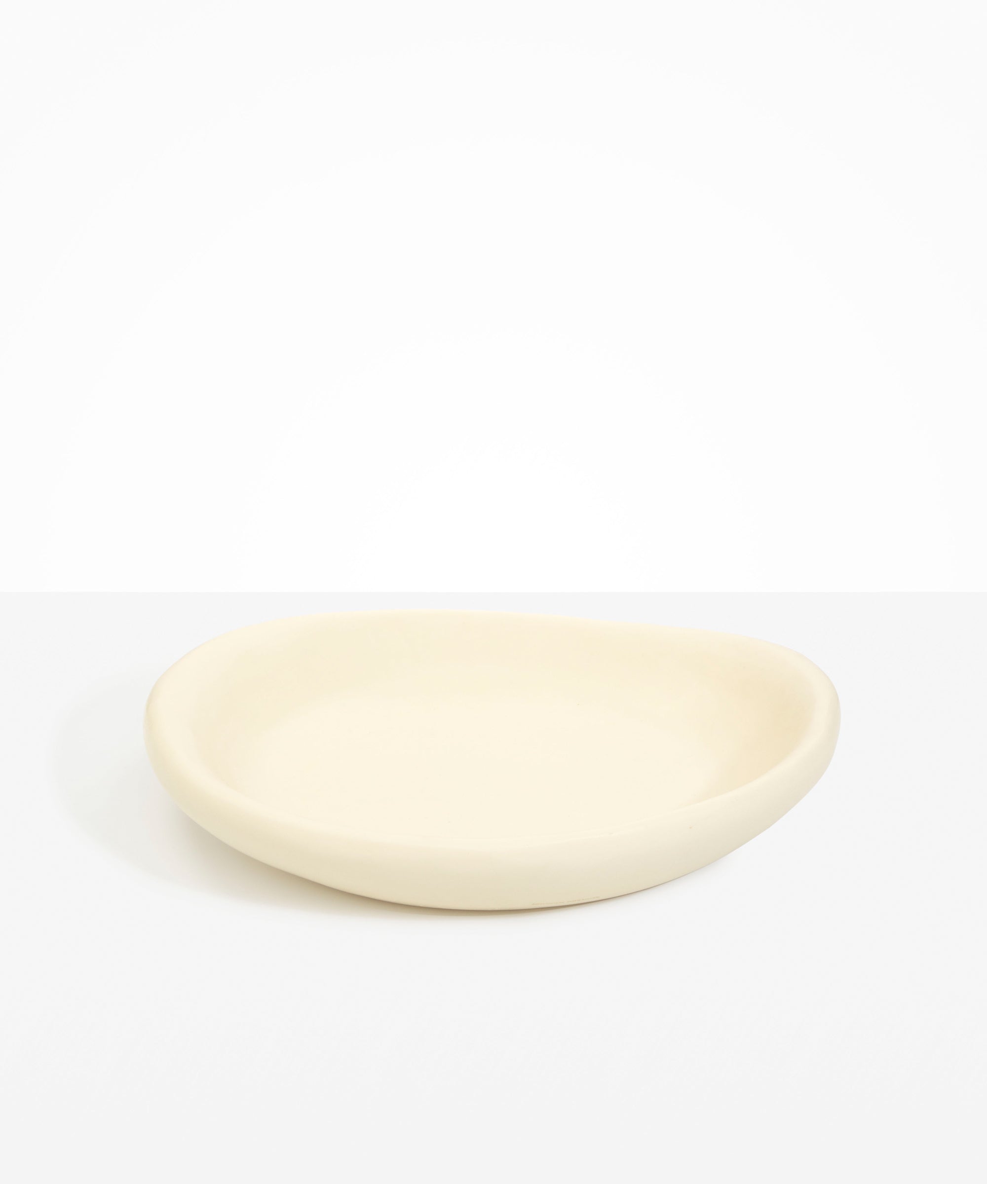 Dinosaur Designs Large Bones Bowl in Cream — handmade cream resin shallow serving bowl with a rounded organic form..