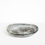 Dinosaur Designs Large Bones Bowl in Granite — handmade marbled cream and grey resin shallow serving bowl with a rounded organic form..