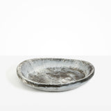 Dinosaur Designs Large Bones Bowl in Granite — handmade marbled cream and grey resin shallow serving bowl with a rounded organic form..