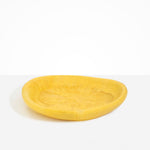 Dinosaur Designs Large Bones Bowl in Pollen — handmade marbled yellow resin shallow serving bowl with a rounded organic form..