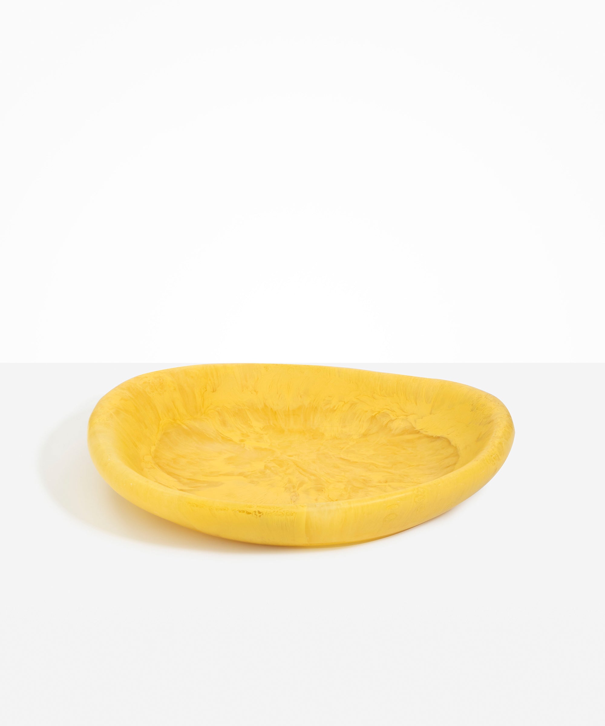 Dinosaur Designs Large Bones Bowl in Pollen — handmade marbled yellow resin shallow serving bowl with a rounded organic form..
