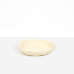 Dinosaur Designs Small Bones Bowl in Cream — small handmade cream resin shallow serving bowl with a rounded organic form