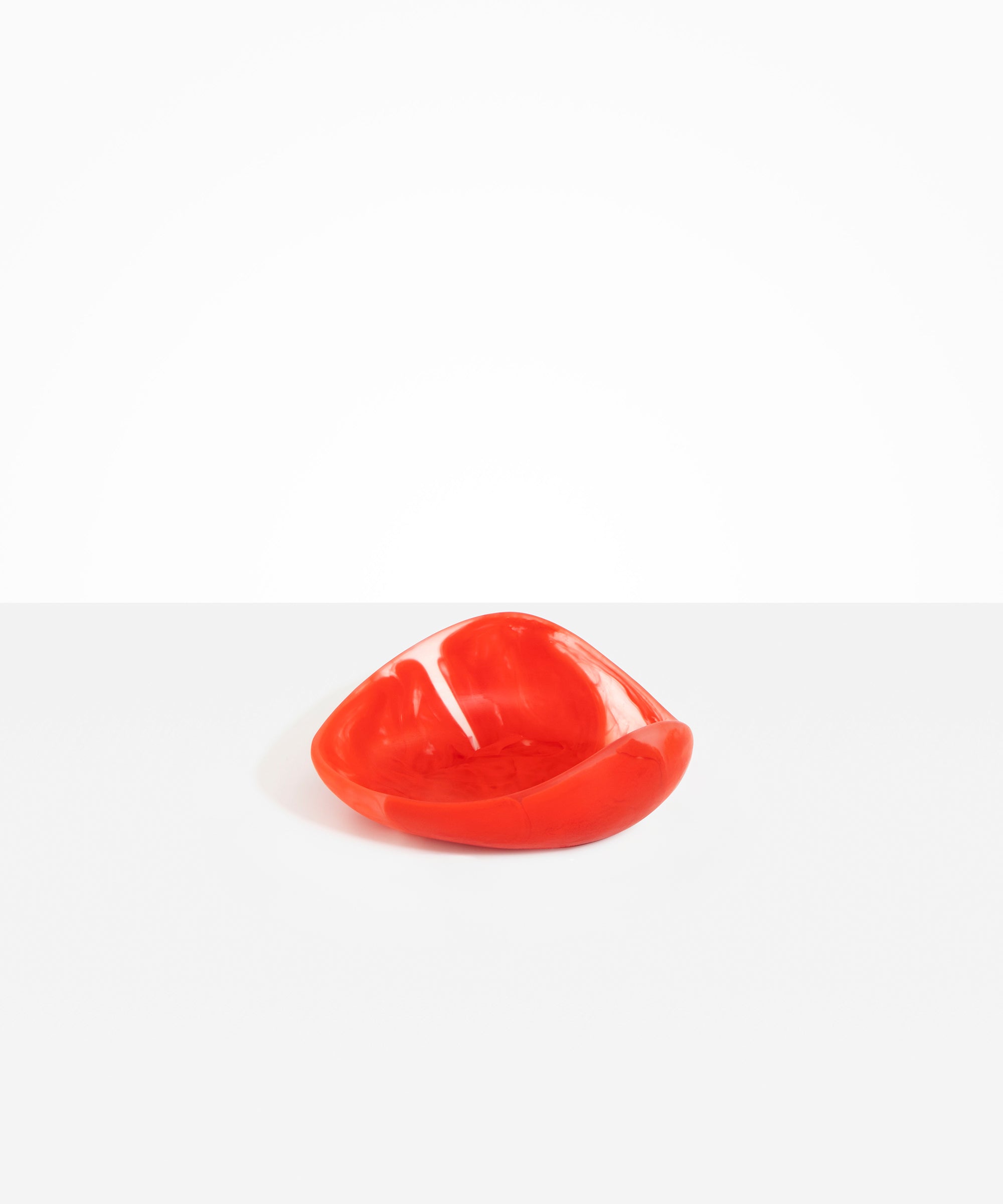 Dinosaur Designs Small Leaf Bowl in Poppy — handcrafted marbled red and transparent resin bowl with curved organic form
