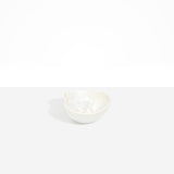 Dinosaur Designs Petal Dessert Bowl in Chalk Swirl — handcrafted marbled off-white resin bowl with curved form and pinched organic rim