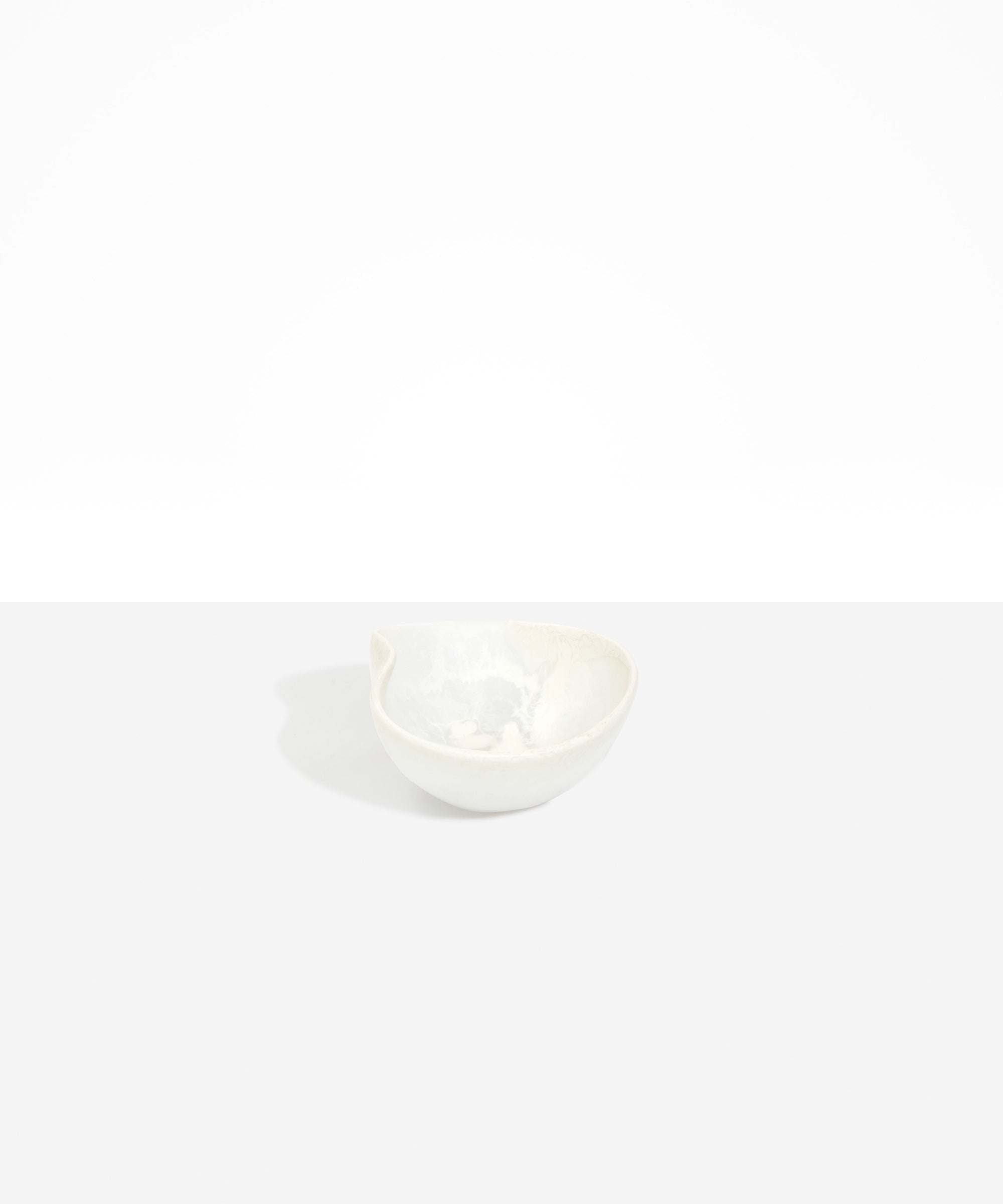 Dinosaur Designs Petal Dessert Bowl in Chalk Swirl — handcrafted marbled off-white resin bowl with curved form and pinched organic rim