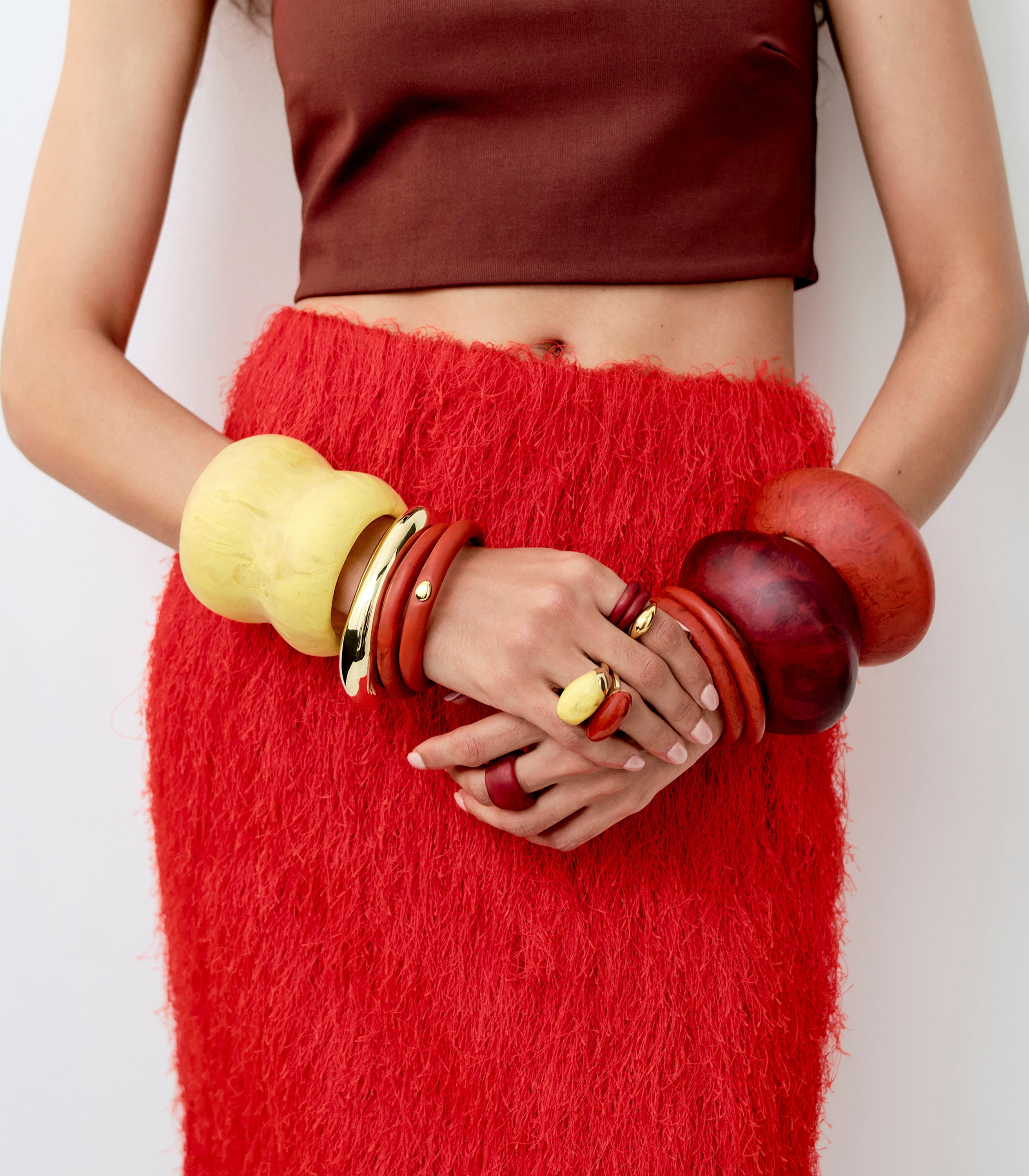 Dinosuar Designs stacked coloured resin bangles with brass bangles