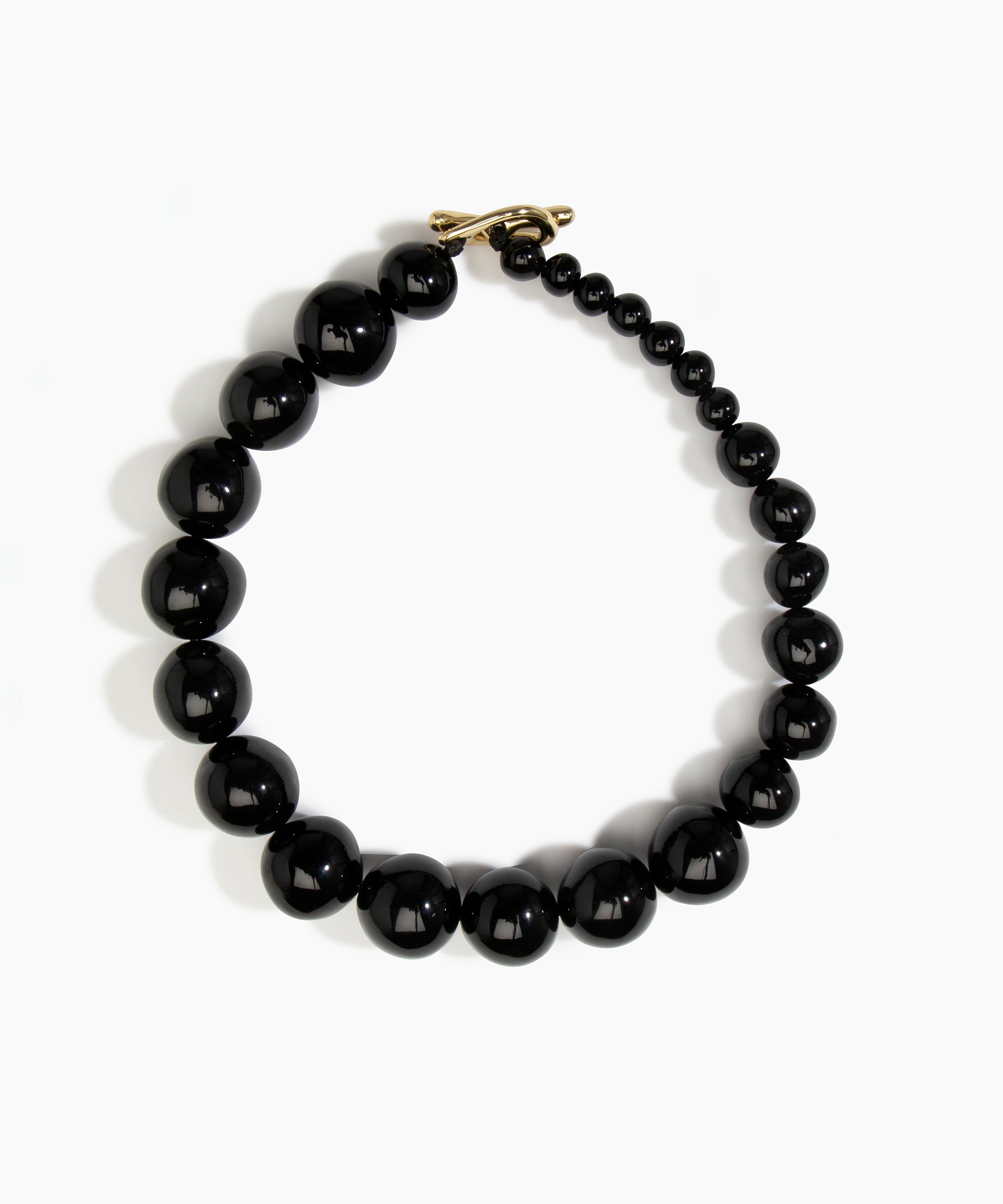 Dinosaur Designs Polished Organic Ball Choker in Black — handcrafted black polished resin graduating bead choker necklace with brass t-bar clasp.