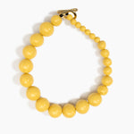 Dinosaur Designs Polished Organic Ball Choker in Pollen — handcrafted marbled yellow and clear polished resin graduating bead choker necklace with brass t-bar clasp