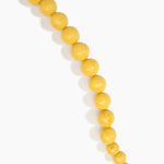 Dinosaur Designs Polished Organic Ball Choker in Pollen — handcrafted marbled yellow and clear polished resin graduating bead choker necklace with brass t-bar clasp