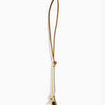 Dinosaur Designs Metal Flower Decoration in Brass — polished brass cast lily-shaped decoration with tan leather hanging loop