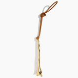 Dinosaur Designs Metal Flower Decoration in Brass — polished brass cast lily-shaped decoration with tan leather hanging loop