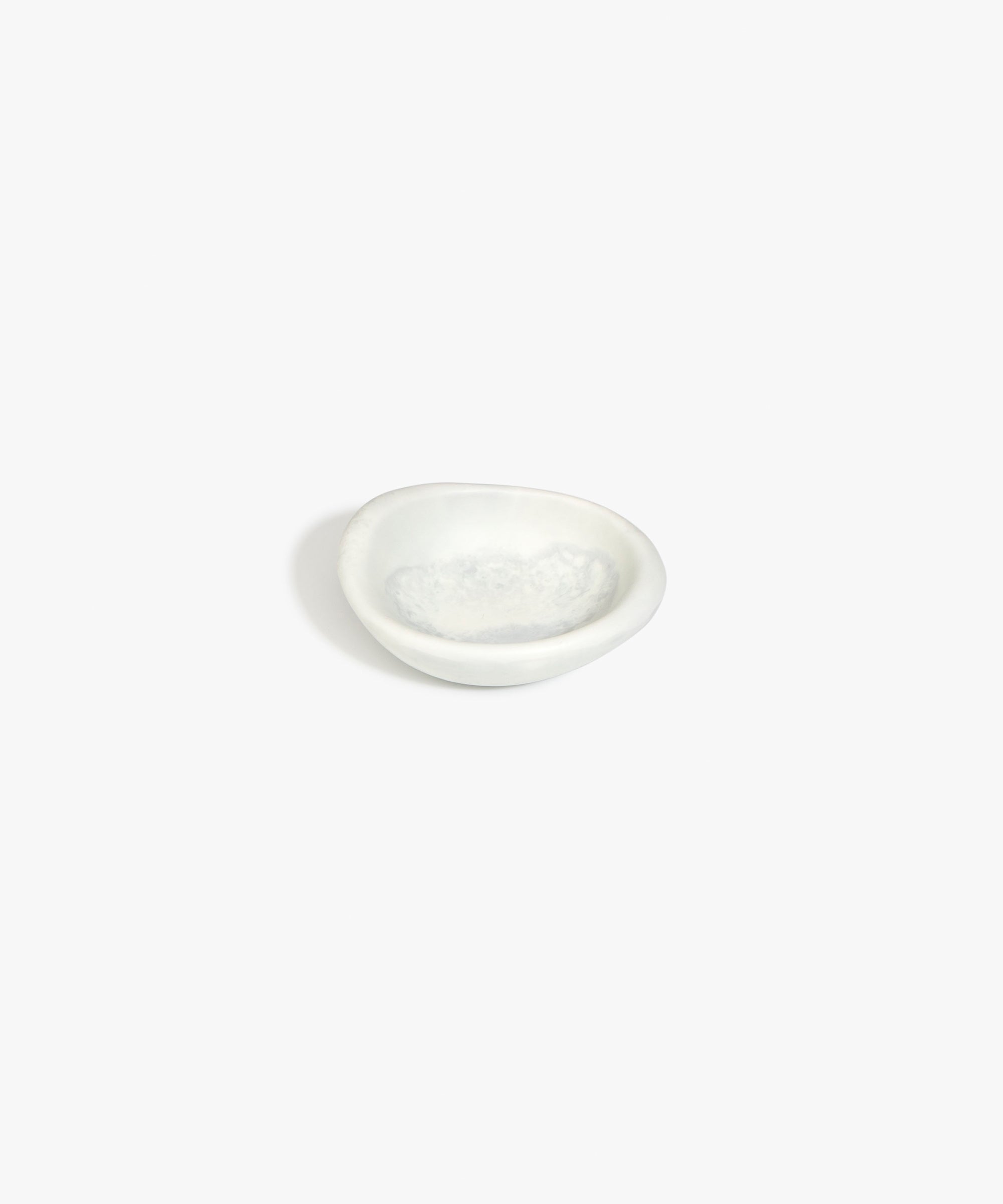 Dinosaur Designs Bones Dish in Cloud — small handcrafted grey and cream marbled resin trinket dish with organic form..