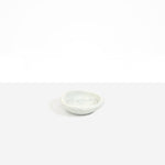 Dinosaur Designs Bones Dish in Cloud — small handcrafted grey and cream marbled resin trinket dish with organic form..