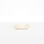 Dinosaur Designs Bones Dish in Chalk Swirl — handcrafted marbled off-white resin trinket dish with pinched bone-shaped organic form