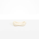 Dinosaur Designs Bones Dish in Chalk Swirl — handcrafted marbled off-white resin trinket dish with pinched bone-shaped organic form