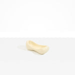 Dinosaur Designs Bones Dish in Cream — handcrafted cream resin trinket dish with pinched bone-shaped organic form