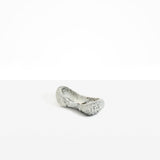 Dinosaur Designs Bones Dish in Granite — handcrafted marbled grey and cream resin trinket dish with pinched bone-shaped organic form.