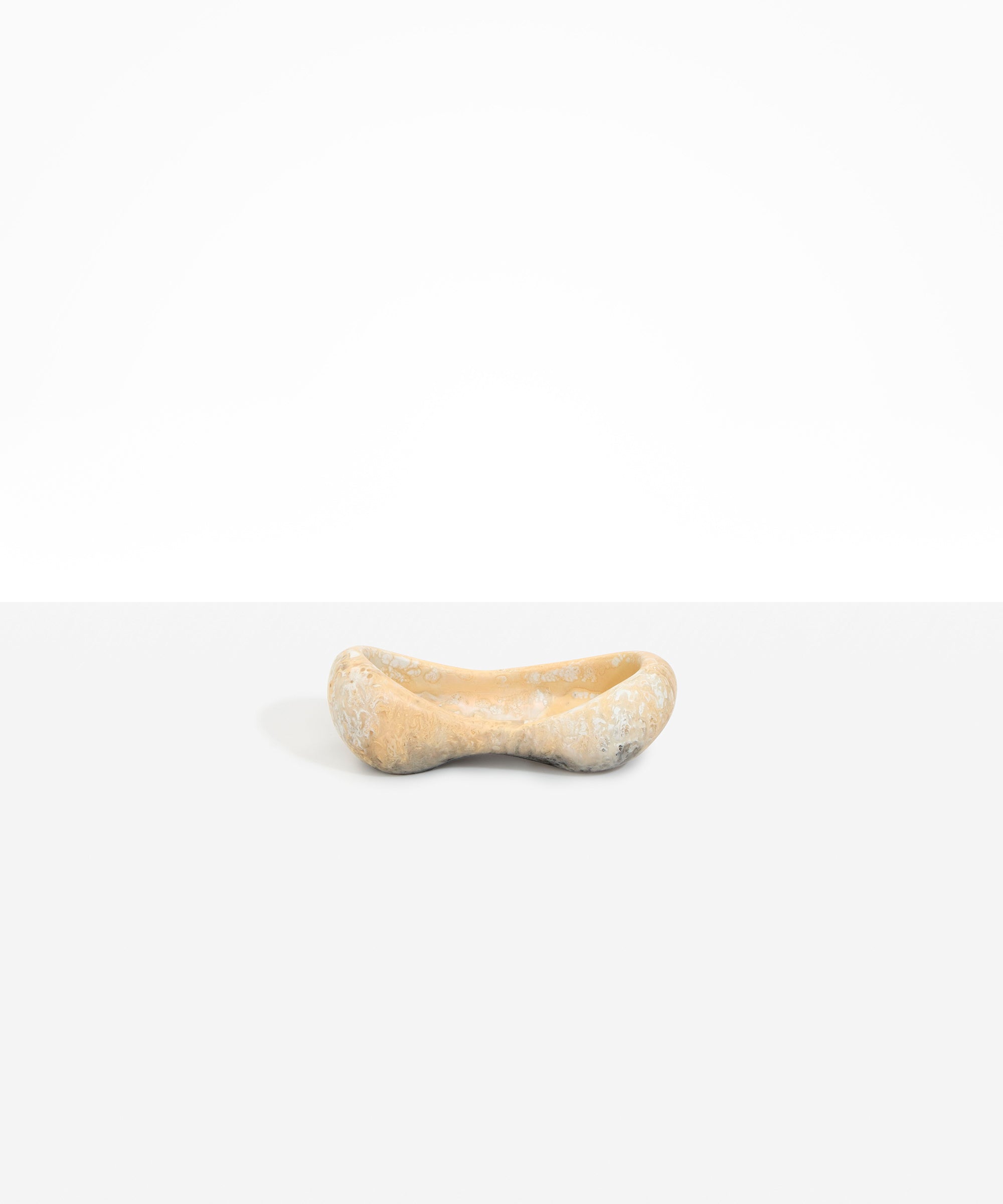 Dinosaur Designs Bones Dish in Sandy Pearl — handcrafted marbled beige and pearlescent resin trinket dish with pinched bone-shaped organic form