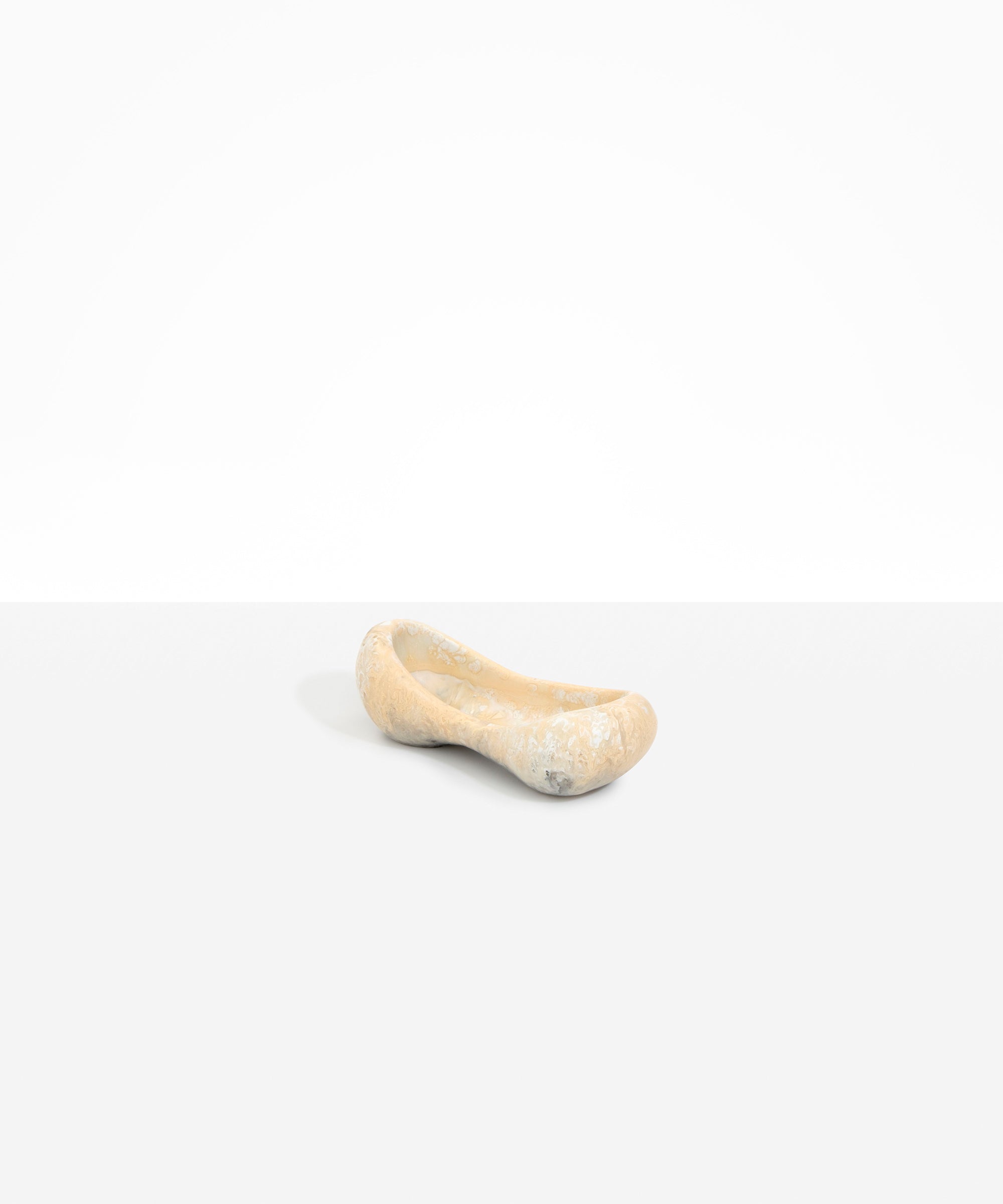 Dinosaur Designs Bones Dish in Sandy Pearl — handcrafted marbled beige and pearlescent resin trinket dish with pinched bone-shaped organic form