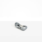 Dinosaur Designs Bones Dish in Slate — handcrafted marbled black and pearlescent resin trinket dish with pinched bone-shaped organic form.