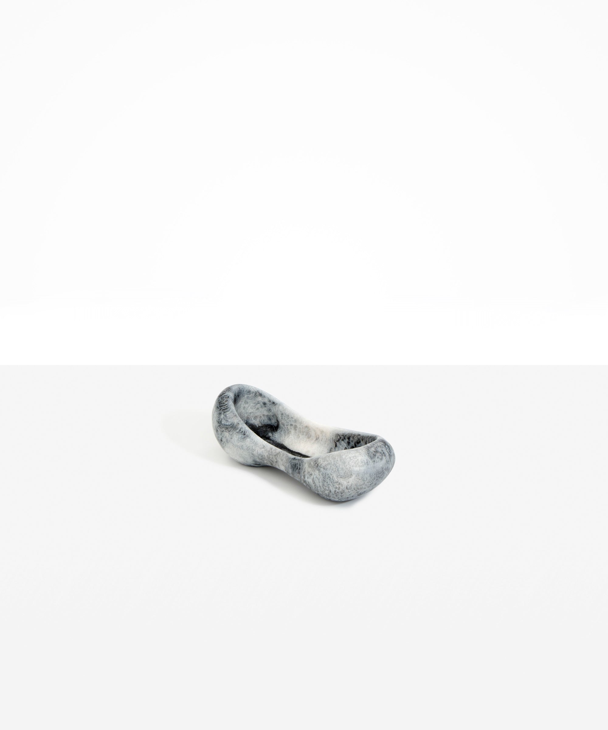 Dinosaur Designs Bones Dish in Slate — handcrafted marbled black and pearlescent resin trinket dish with pinched bone-shaped organic form.