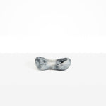 Dinosaur Designs Bones Dish in Slate — handcrafted marbled black and pearlescent resin trinket dish with pinched bone-shaped organic form.
