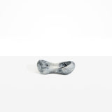 Dinosaur Designs Bones Dish in Slate — handcrafted marbled black and pearlescent resin trinket dish with pinched bone-shaped organic form.