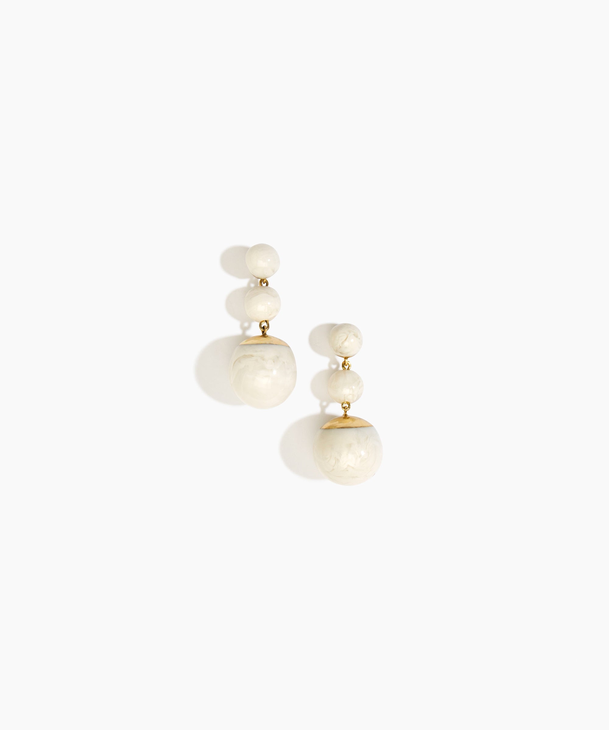 Dinosaur Designs Full Moon Drop Earrings in Chalk Swirl with Brass — marbled off-white resin graduating bead drop earrings with brass fittings..
