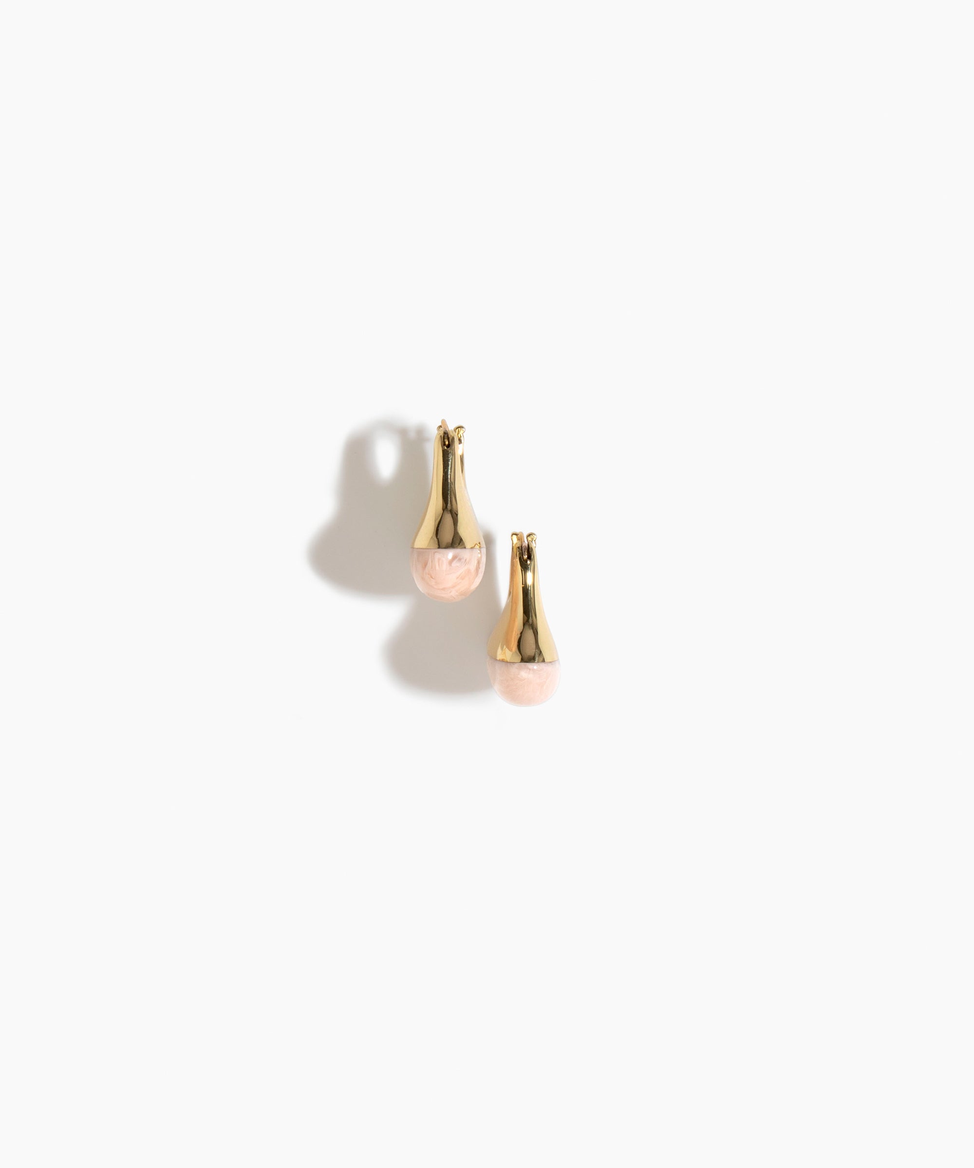 Dinosaur Designs Polished Lotus Hoop Earrings in Rose Swirl with Brass — marbled dusty pink resin half-dome hoop earrings with polished brass hardware and hinged clasp