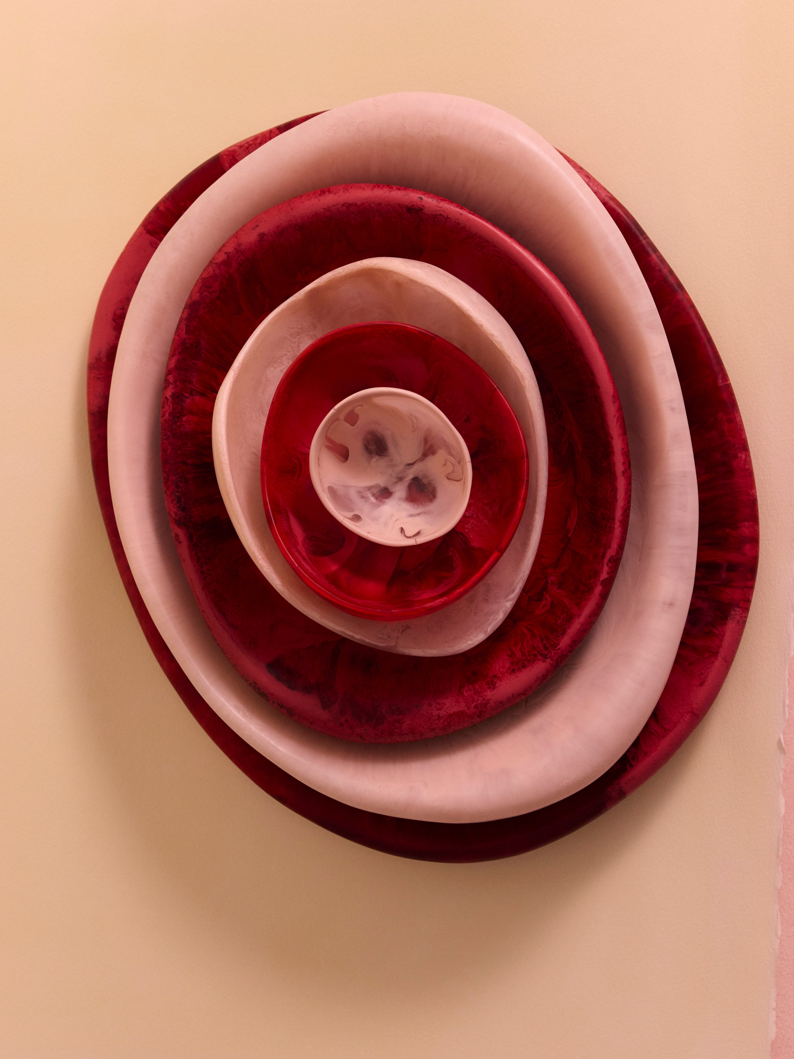 Stack of pink and red resin bowls