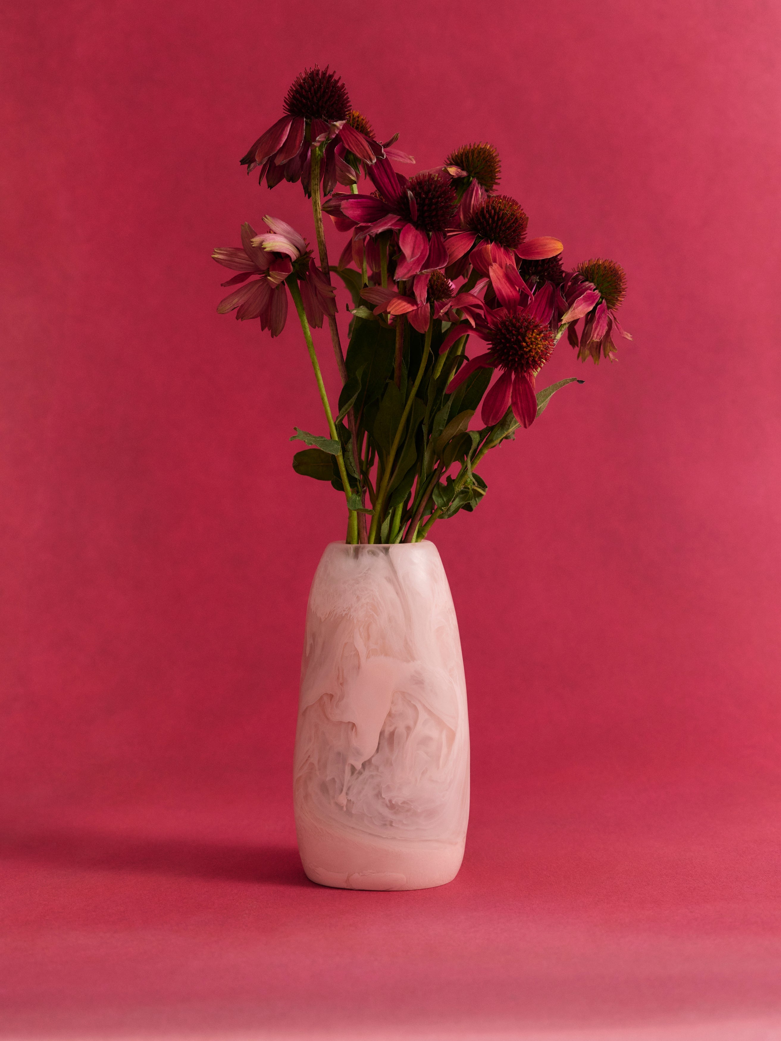 Decorative pink resin with floral arrangement on a pink background
