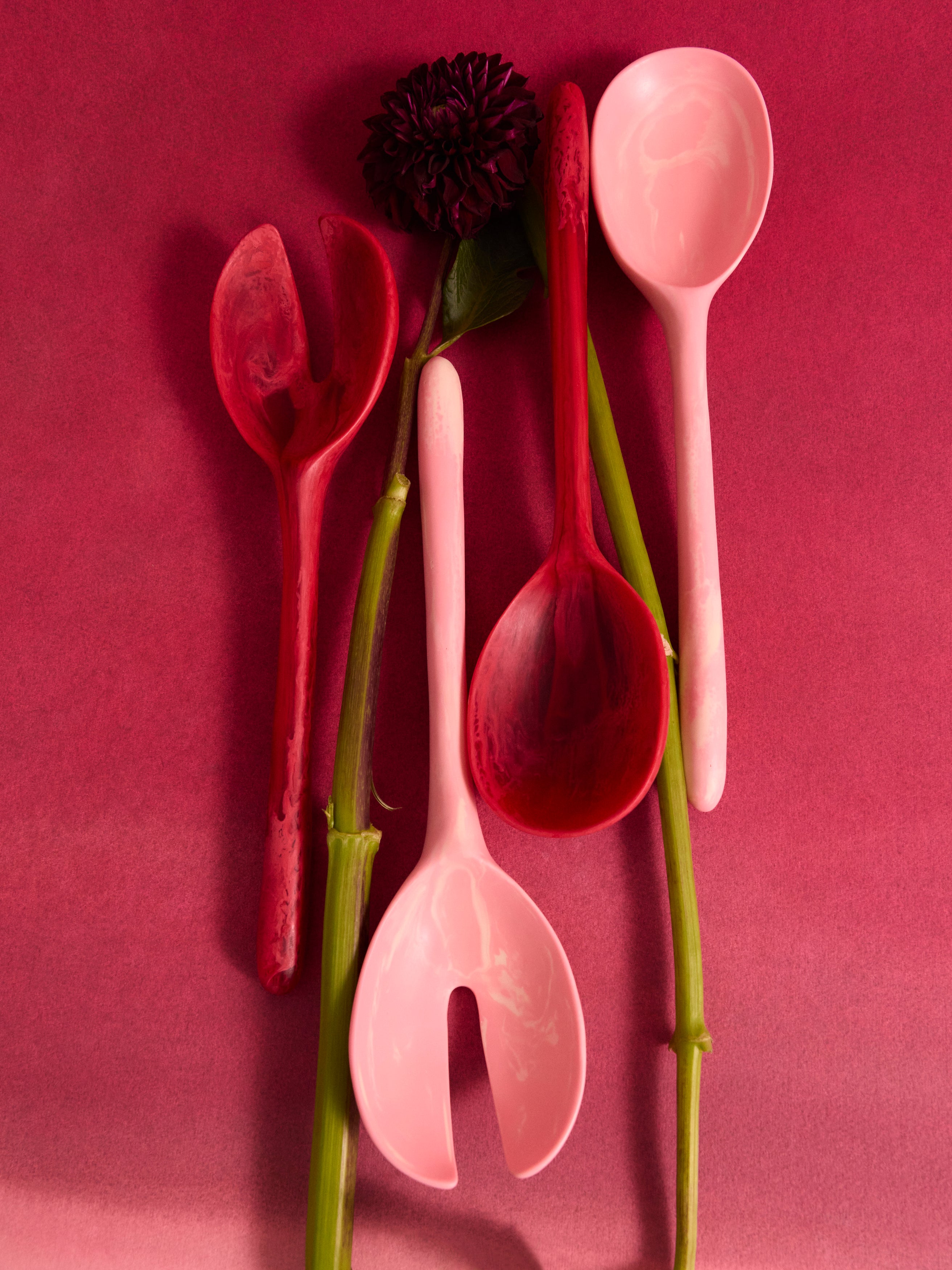Pink and red resin serving spoon with a single flower stem