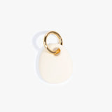 Dinosaur Designs Earth Keyring in Cream — handcrafted Cream resin pebble bead on a polished brass jump ring
