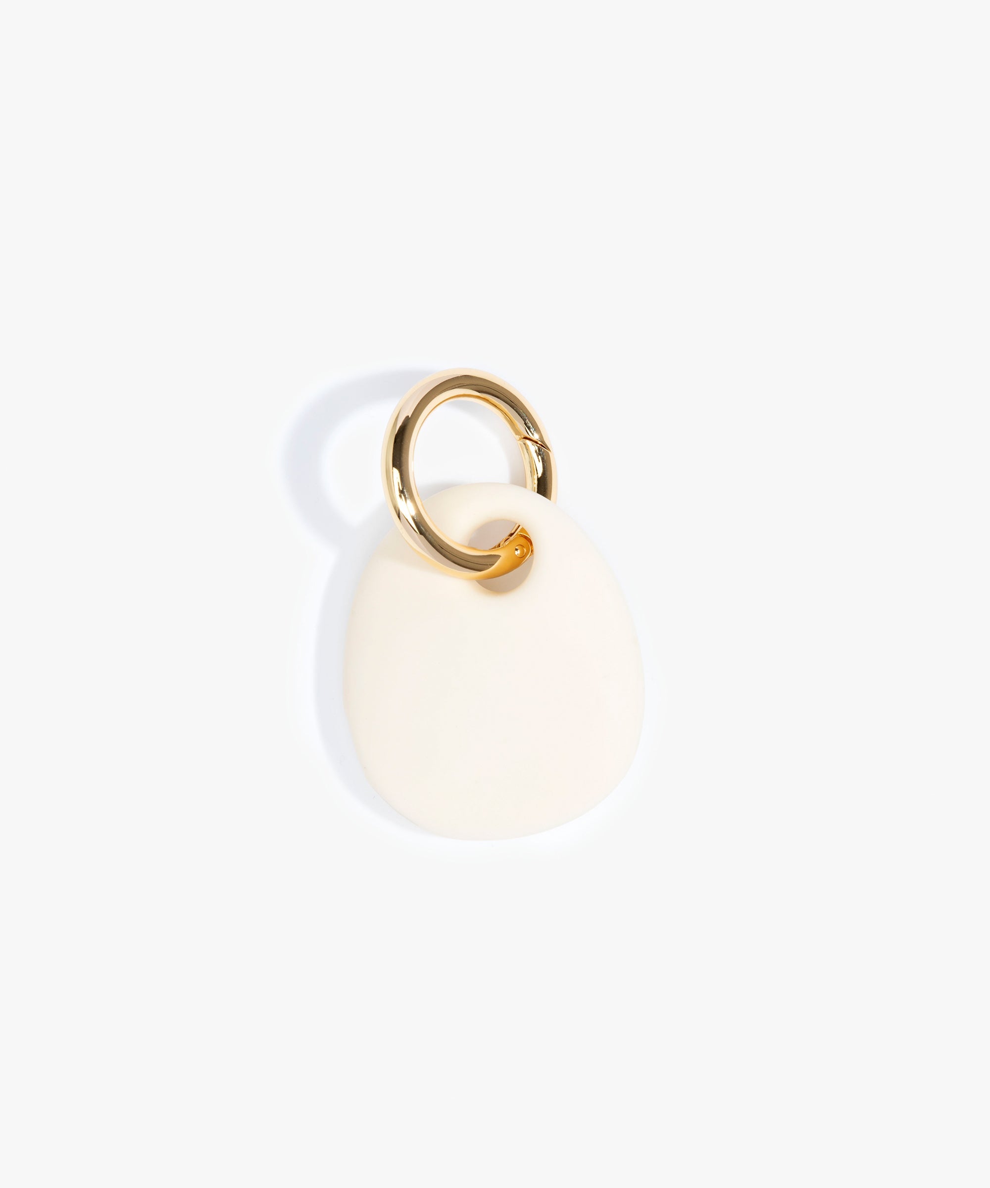 Dinosaur Designs Earth Keyring in Cream — handcrafted Cream resin pebble bead on a polished brass jump ring