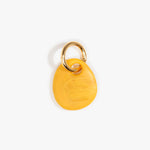 Dinosaur Designs Earth Keyring in Honeycomb — handcrafted marbled mustard yellow resin pebble bead on a polished brass jump ring