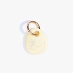 Dinosaur Designs Earth Keyring in Lemon — handcrafted marbled pastel yellow resin pebble bead on a polished brass jump ring