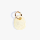 Dinosaur Designs Earth Keyring in Lemon — handcrafted marbled pastel yellow resin pebble bead on a polished brass jump ring