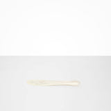 Dinosaur Designs Temple Cake Knife in Chalk Swirl — handcrafted marbled off white resin cake knife with smooth tapered blade and rounded handle