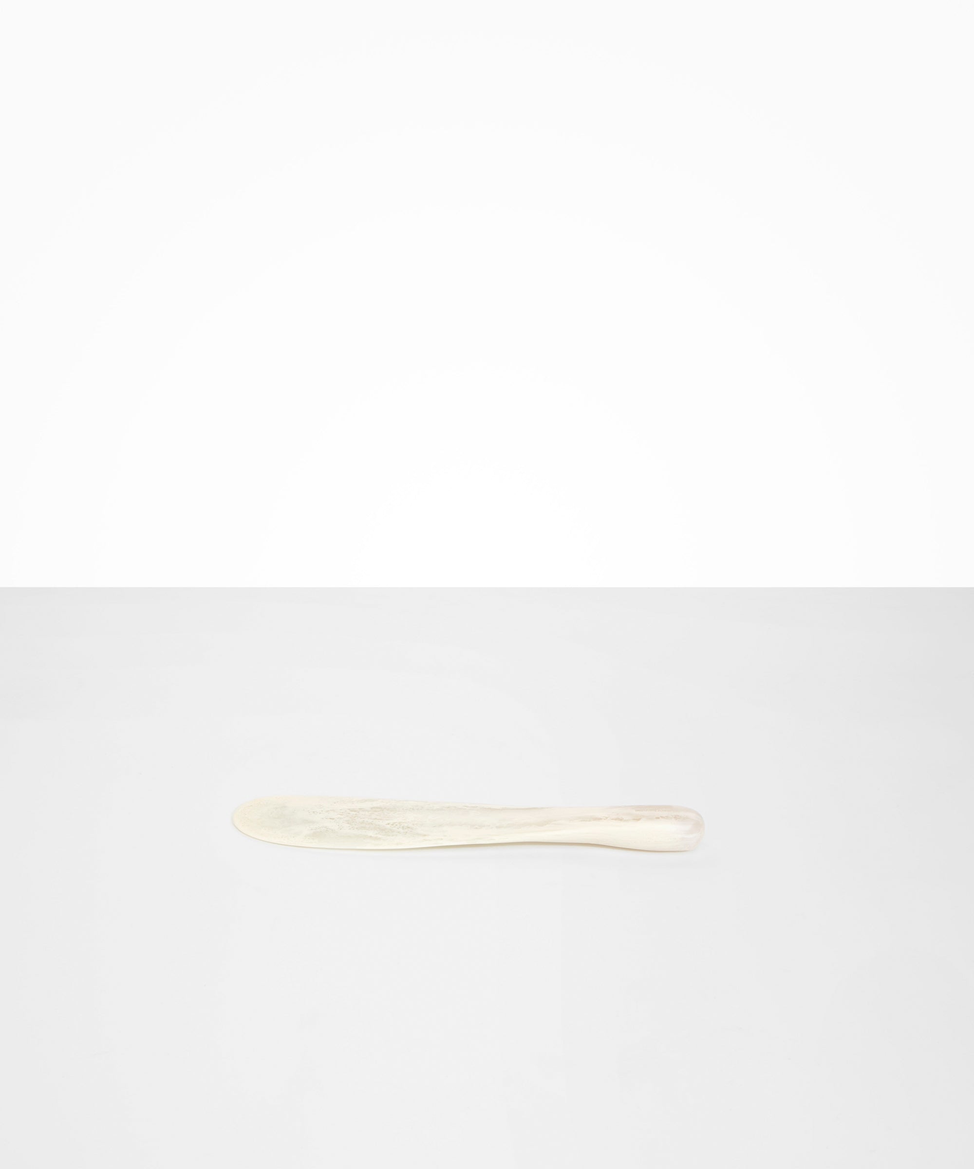 Dinosaur Designs Temple Cake Knife in Chalk Swirl — handcrafted marbled off white resin cake knife with smooth tapered blade and rounded handle