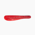 Dinosaur Designs Temple Cake Knife in Cranberry — handcrafted marbled red resin cake knife with smooth tapered blade and rounded handle