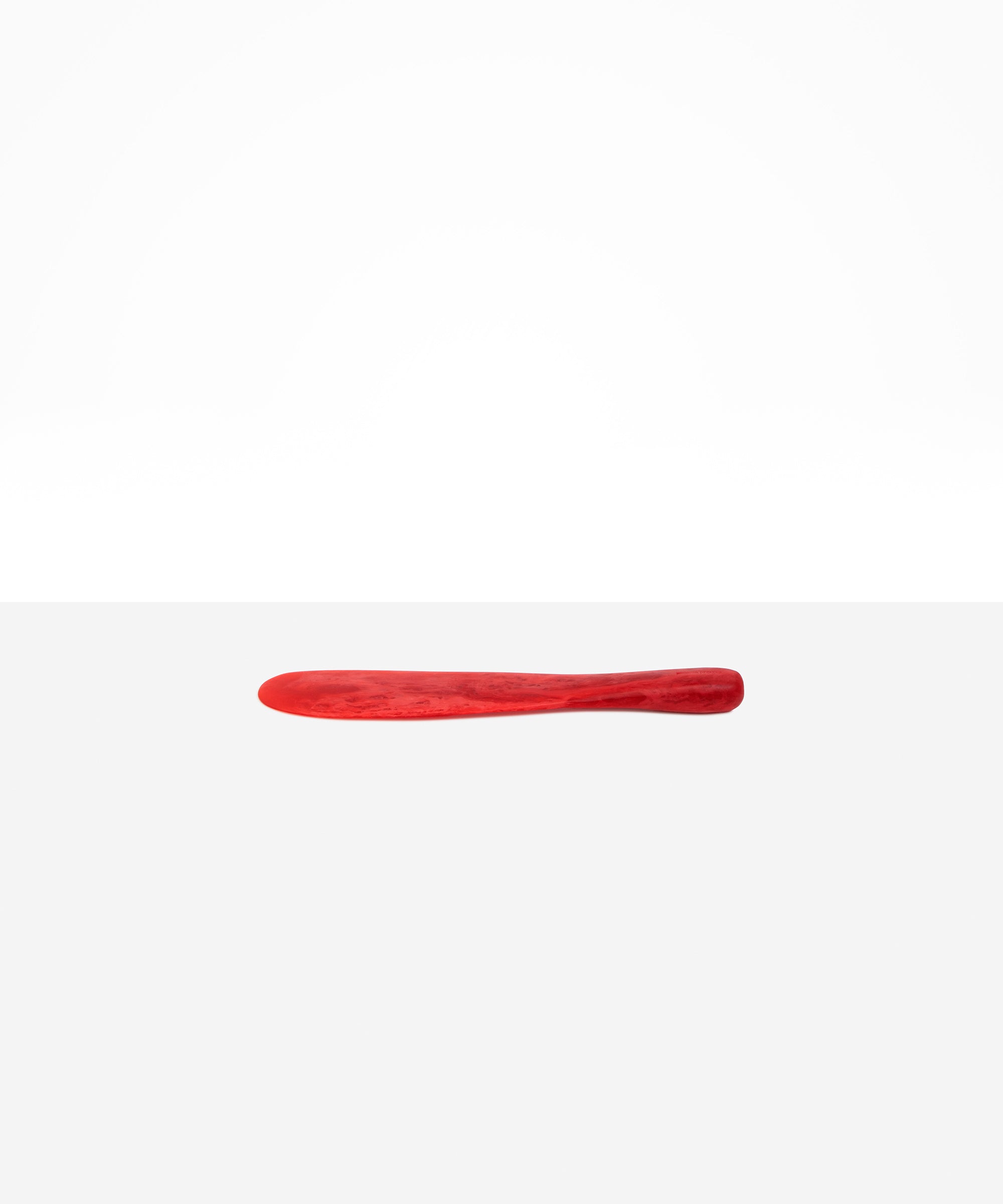 Dinosaur Designs Temple Cake Knife in Cranberry — handcrafted marbled red resin cake knife with smooth tapered blade and rounded handle