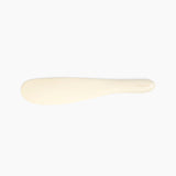 Dinosaur Designs Temple Cake Knife in Cream — handcrafted cream resin cake knife with smooth tapered blade and rounded handle